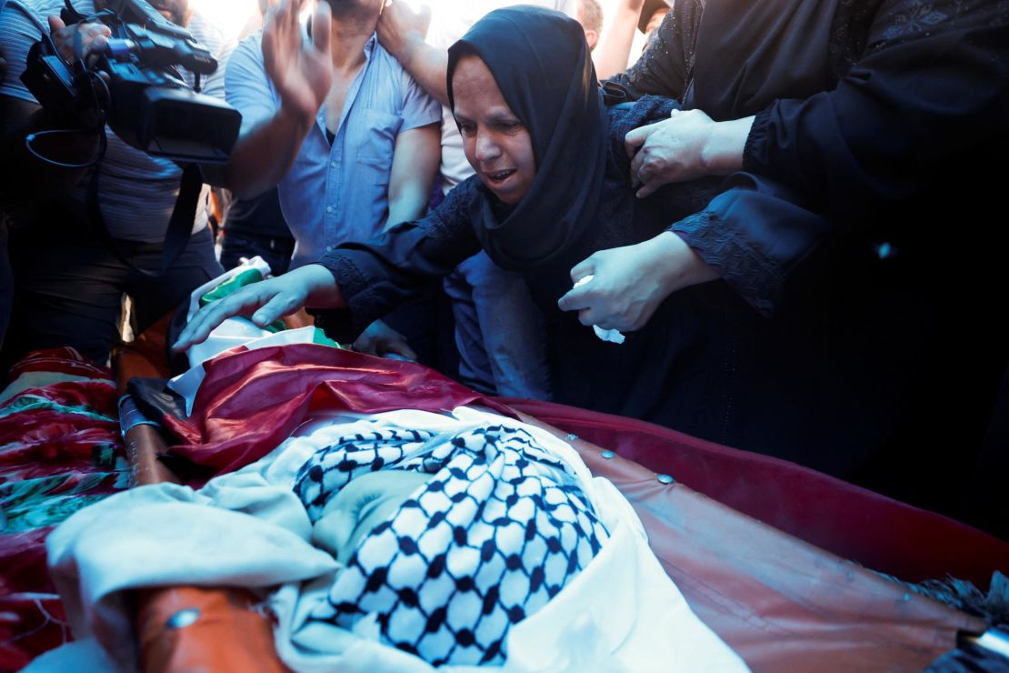 People mourn during the funeral of seven-year-old Rayyan Suleiman.