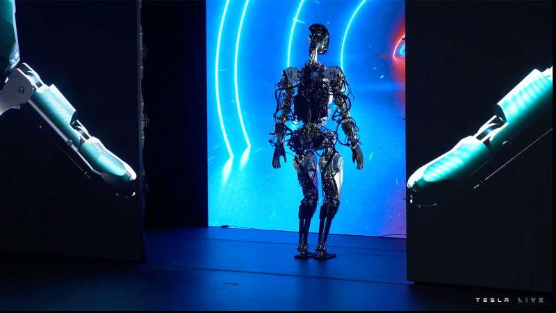 Tesla robot slowly walks on stage at AI Day – CNN