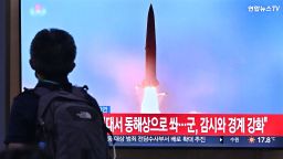 A man walks past a television screen showing a news broadcast with file footage of a North Korean missile test, at a railway station in Seoul on September 29, 2022. - North Korea fired two ballistic missiles on September 29, just hours after US Vice President Kamala Harris left South Korea, where she had toured the heavily-fortified Demilitarized Zone which divides the peninsula. (Photo by Jung Yeon-je / AFP) (Photo by JUNG YEON-JE/AFP via Getty Images)