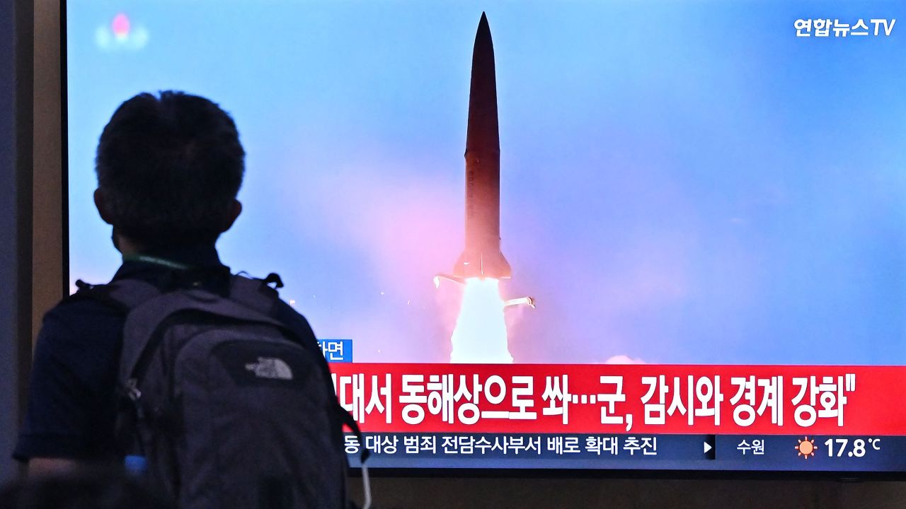 A man walks past a television screen showing a news broadcast with file footage of a North Korean missile test, at a - North Korea fired two ballistic missiles on September 29, just hours after US Vice President Kamala Harris left South Korea, where she had toured the heavily-fortified Demilitarized Zone which divides the peninsula. (Photo by Jung Yeon-je / AFP) (Photo by JUNG YEON-JE/AFP via Getty Images)