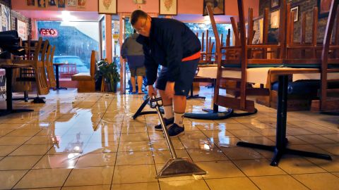 Flood waters are suctioned from inside a restaurant near where Hurricane Ian made landfall in Georgetown, South Carolina, on September 30, 2022.