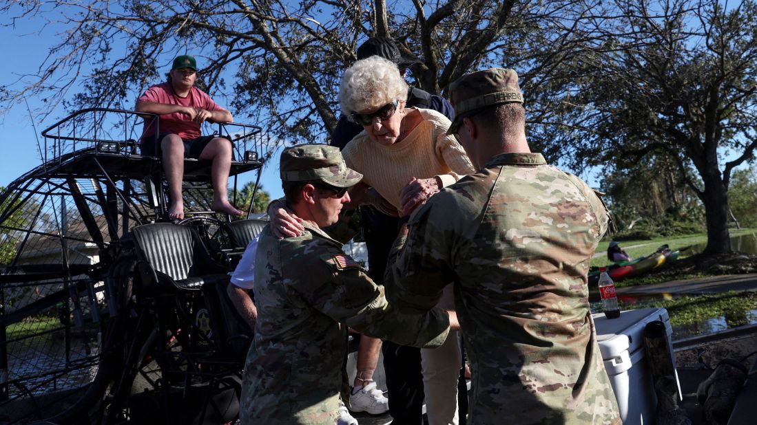 Members of the US Army National Guard help people evacuate from flood waters in North Port, Florida, on Friday, September 30.