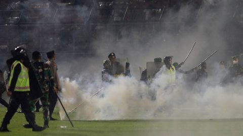 Supporters from the losing team "invaded" the pitch and police fired tear gas, triggering a stampede that led to cases of suffocation, police said.