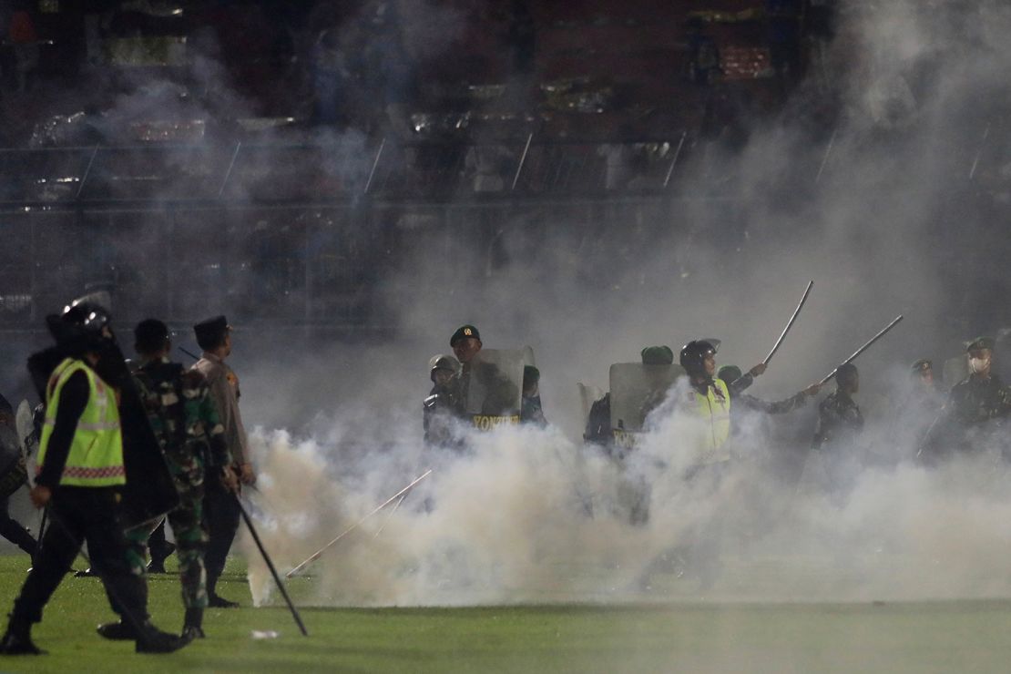 Supporters from the losing team "invaded" the pitch and police fired tear gas, triggering a fan crush that led to cases of suffocation, police said.