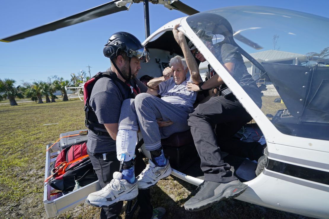 Members of mediccorps.org help evacuate Tom Acerbo on Pine Island, Florida, on Saturday.
