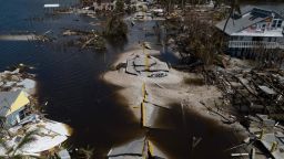 An aerial picture taken on October 1, 2022 shows a broken section of the Pine Island Road, debris and destroyed houses in the aftermath of Hurricane Ian in Matlacha, Florida on October 1, 2022. - Shocked Florida communities counted their dead October 1, 2022, as the full scale of the devastation came into focus, two days after Hurricane Ian tore into the coastline as one of the most powerful storms ever to hit the United States. (Photo by Ricardo ARDUENGO / AFP) (Photo by RICARDO ARDUENGO/AFP via Getty Images)
