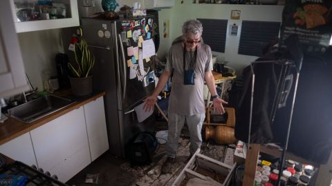 A man reacts inside his destroyed trailer home in the aftermath of Hurricane Ian in Matlacha, Florida, Saturday.