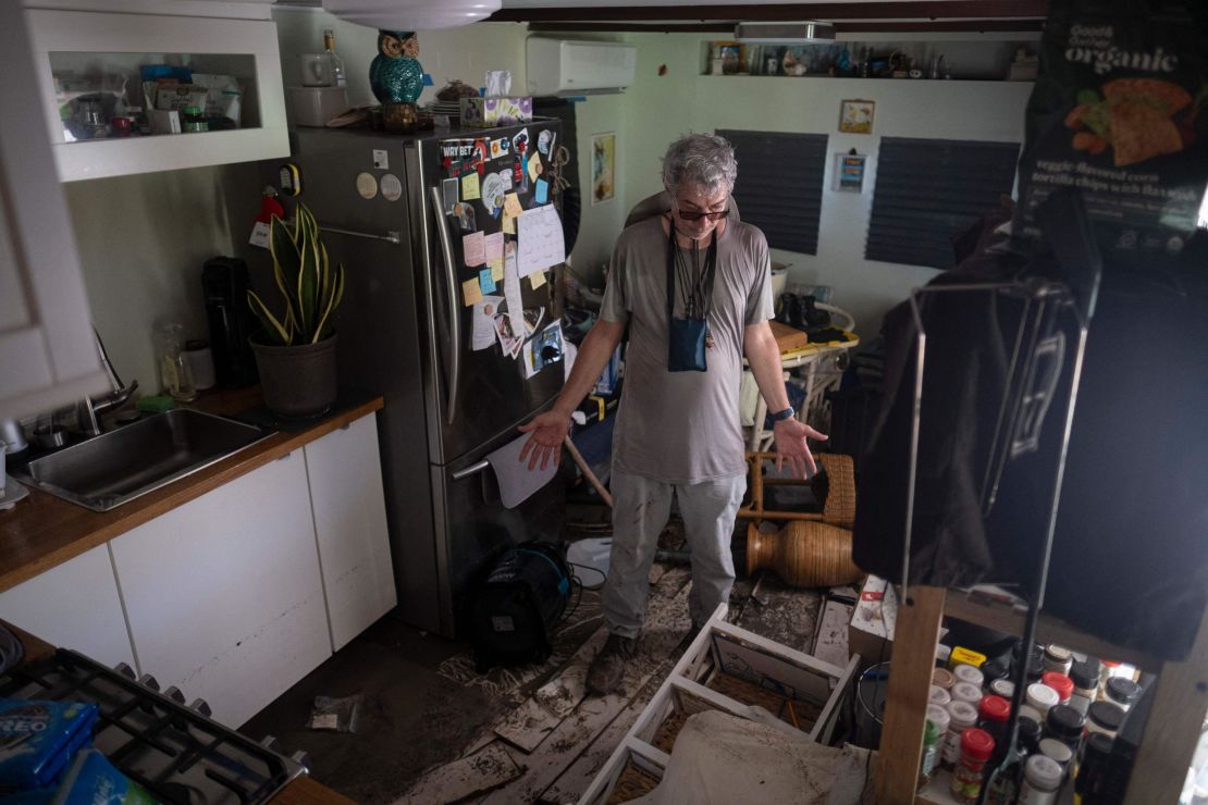 A man surveys his damaged trailer home Saturday in Matlacha, Florida.