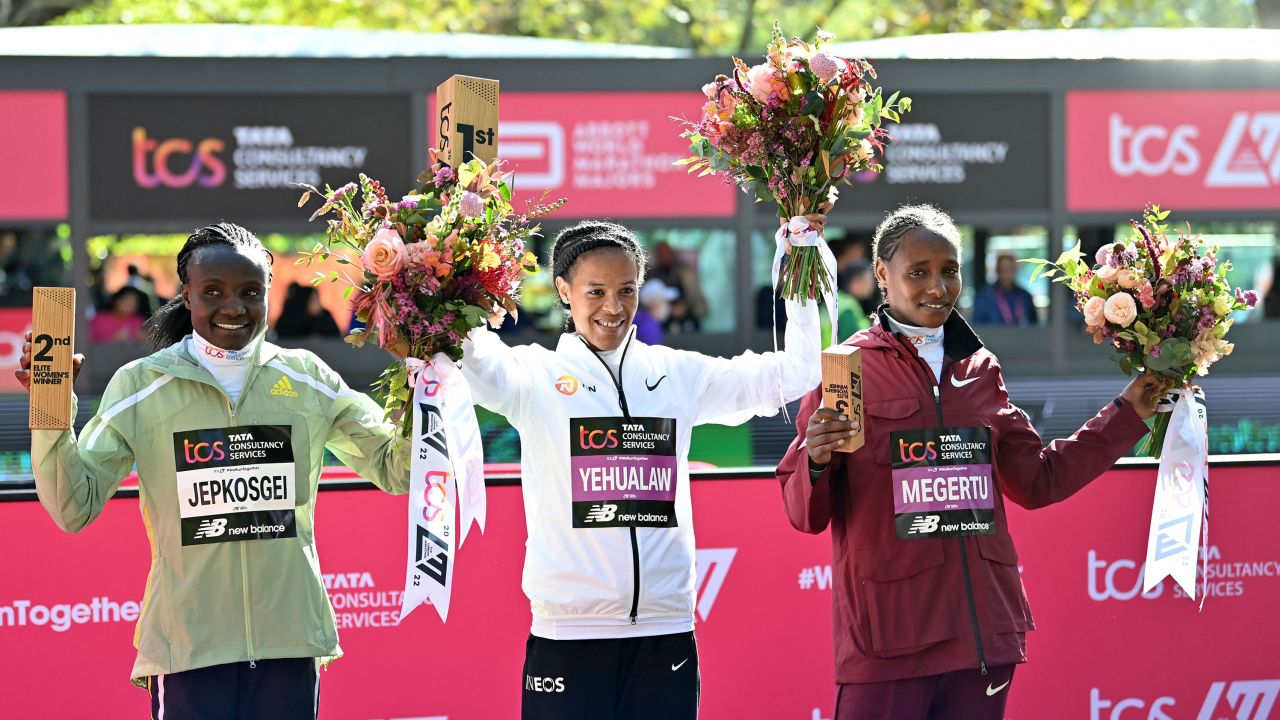(L-R) Runner-up Kenya's Joyciline Jepkosgei, winner, Ethiopia's Yalemzerf Yehualaw, third place, Ethiopia's Alemu Megertu, celebrate at the finishing line. 