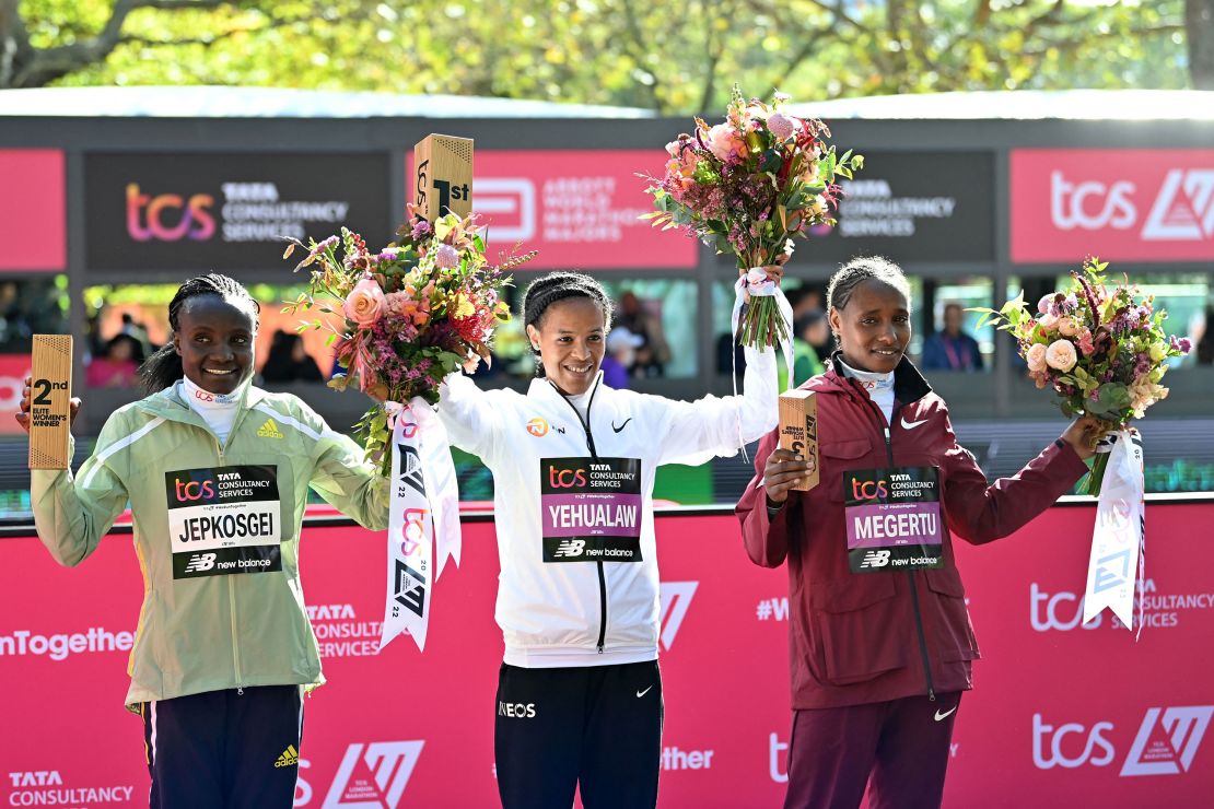 (L-R) Runner-up Kenya's Joyciline Jepkosgei, winner, Ethiopia's Yalemzerf Yehualaw, third place, Ethiopia's Alemu Megertu, celebrate at the finishing line. 