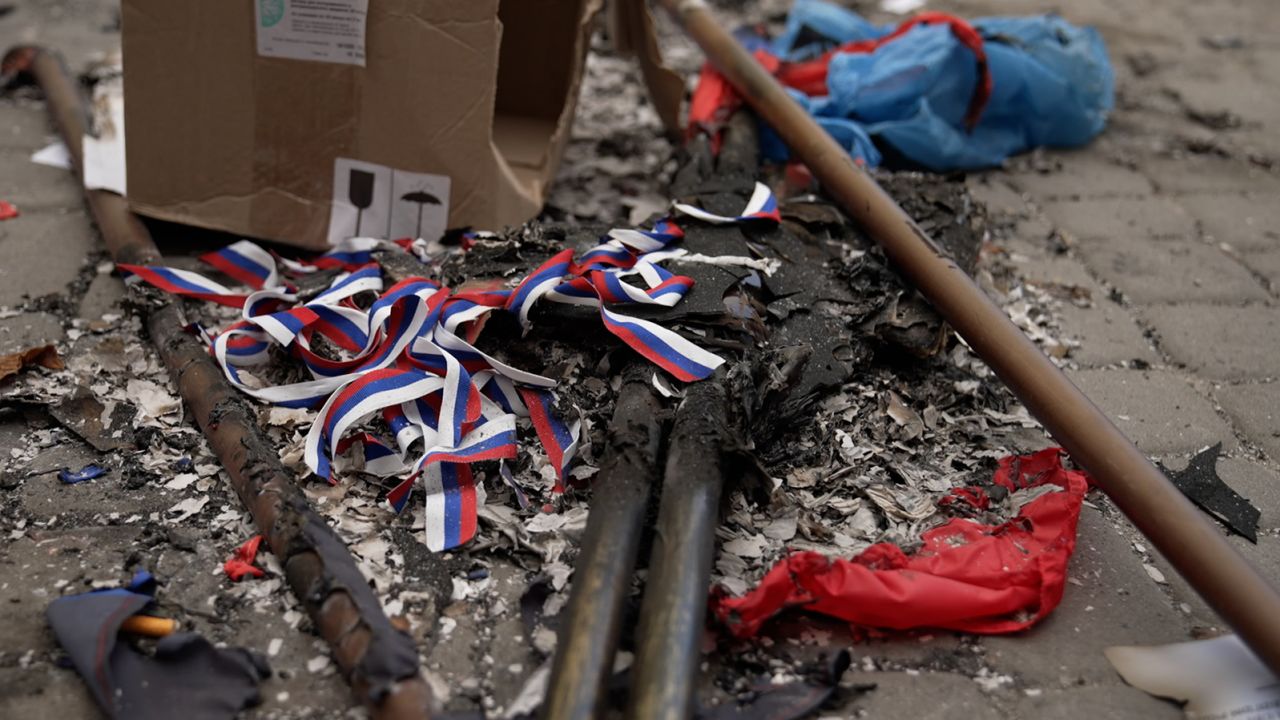 Russian flags and propaganda material after being set alight outside the local administration building in Lyman, Ukraine, on Sunday, October 2, 2022.