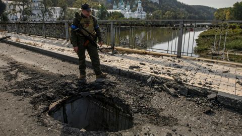 A member of Ukraine's National Guard stands at a bridge over the Siverskyi Donets river in the Donetsk region on October 1, 2022.