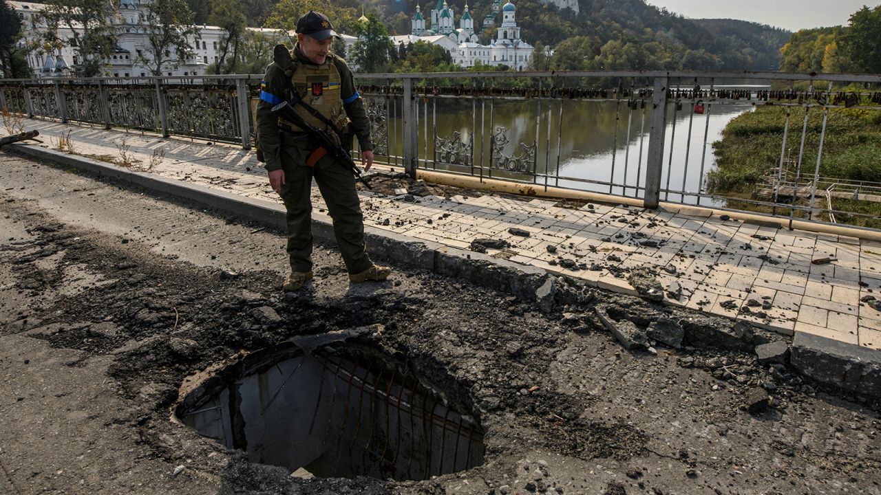 A member of Ukraine's National Guard stands at a bridge over the Siverskyi Donets river in the Donetsk region on October 1, 2022.