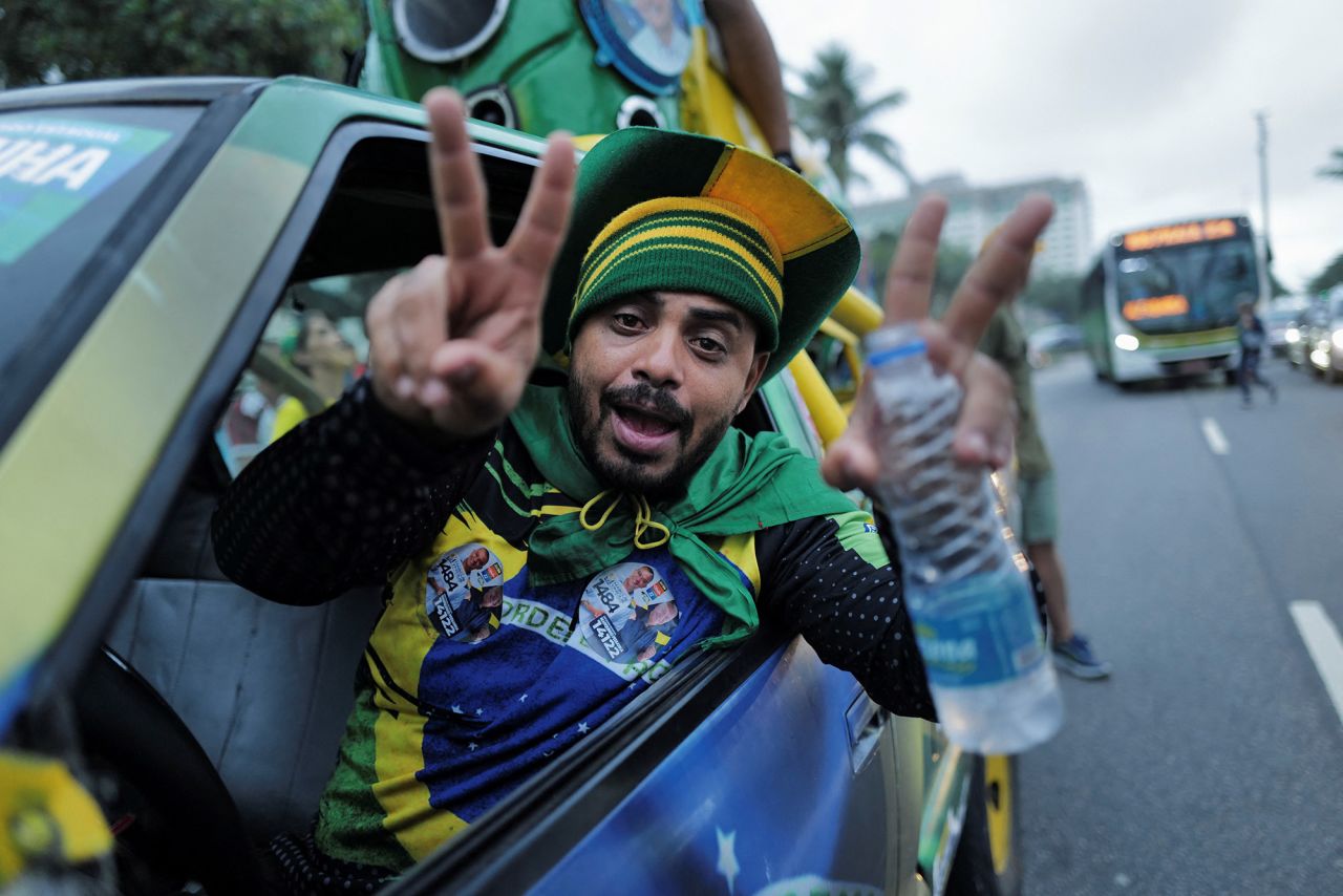 A Bolsonaro supporter gestures at a gathering outside Bolsonaro's home in Rio de Janeiro on October 2.
