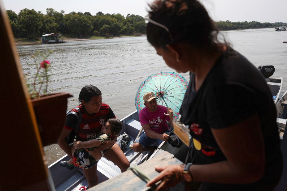 People arrive to cast their votes at a voting station set up on a floating school on the Negro River near Manaus, Brazil, on October 2.<br />
