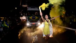 A supporter of Brazilian President Jair Bolsonaro, who is running for another term, celebrates the partial results after general election polls closed in Brasilia, Brazil, Sunday, Oct. 2, 2022.