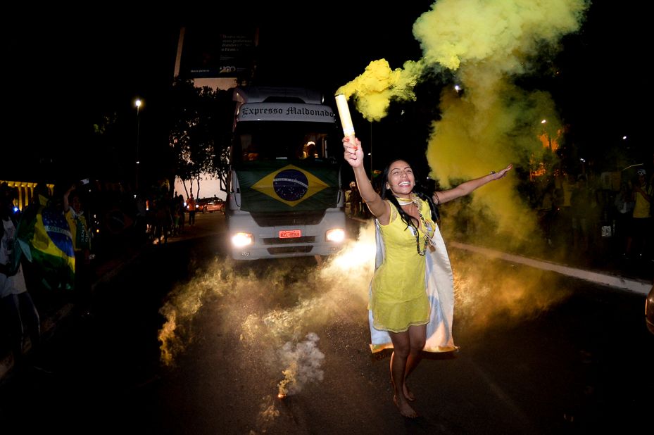 A Bolsonaro supporter celebrates the partial results after general election polls closed in Brasília on October 2.<br />