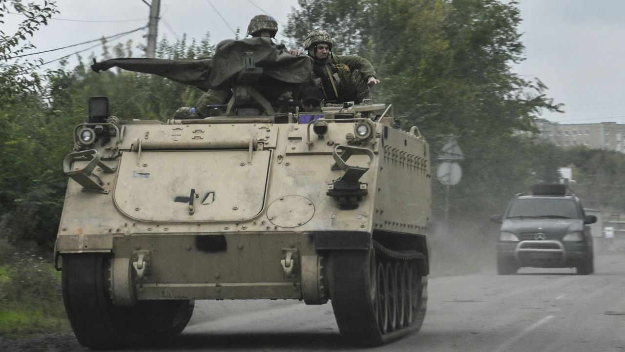 Ukrainian servicemen ride atop an armoured personnel carrier (APC) in Kramatorsk, eastern Ukraine, on October 2, 2022, amid the Russian invasion of Ukraine. (Photo by Juan BARRETO / AFP) (Photo by JUAN BARRETO/AFP via Getty Images)