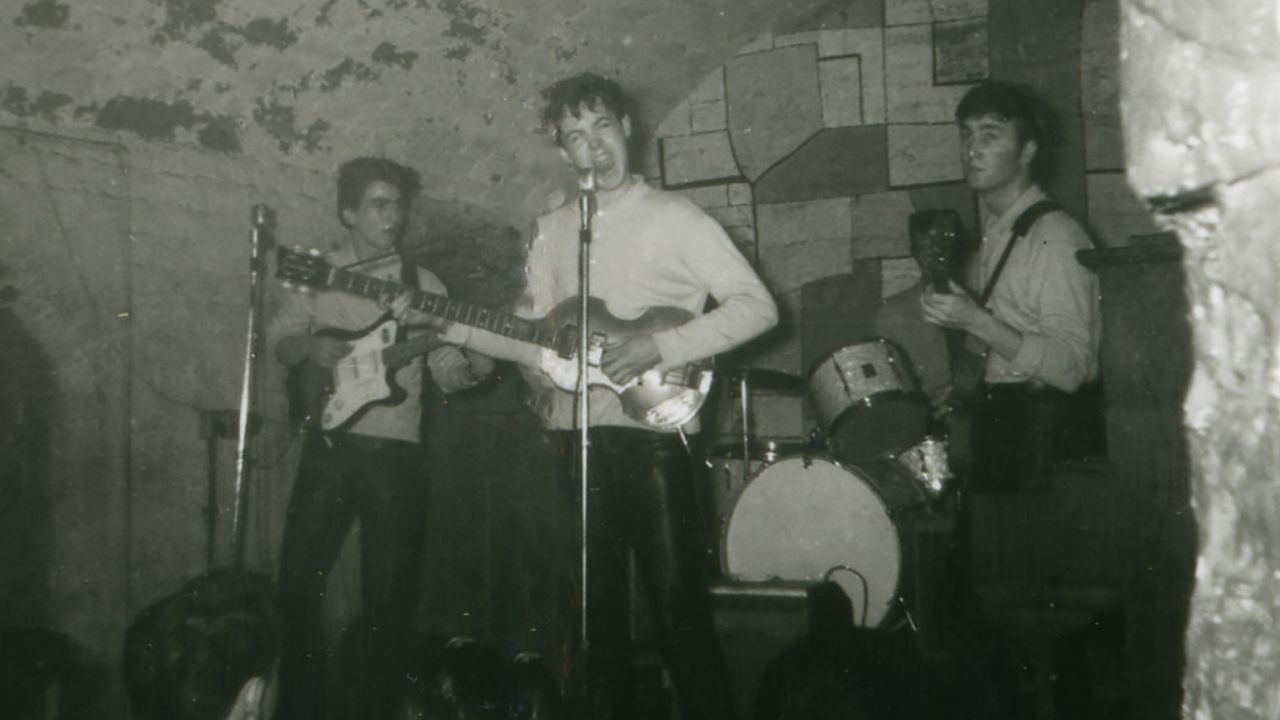 A rare image showing (L-R) George Harrison, Paul McCartney and John Lennon. Drummer Pete Best is partially visible.
