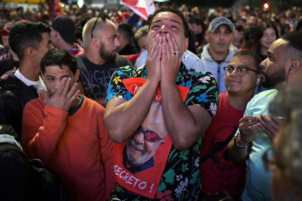 Lula supporters react as they watch the vote count of in Sao Paulo on October 2. Neither candidate got 50% of the vote and it went to a run-off.<br />