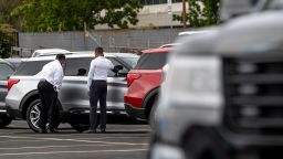 Customers view a vehicle for sale at a Ford Motor Co. dealership in Richmond, California, U.S., on Thursday, July 1, 2021. 