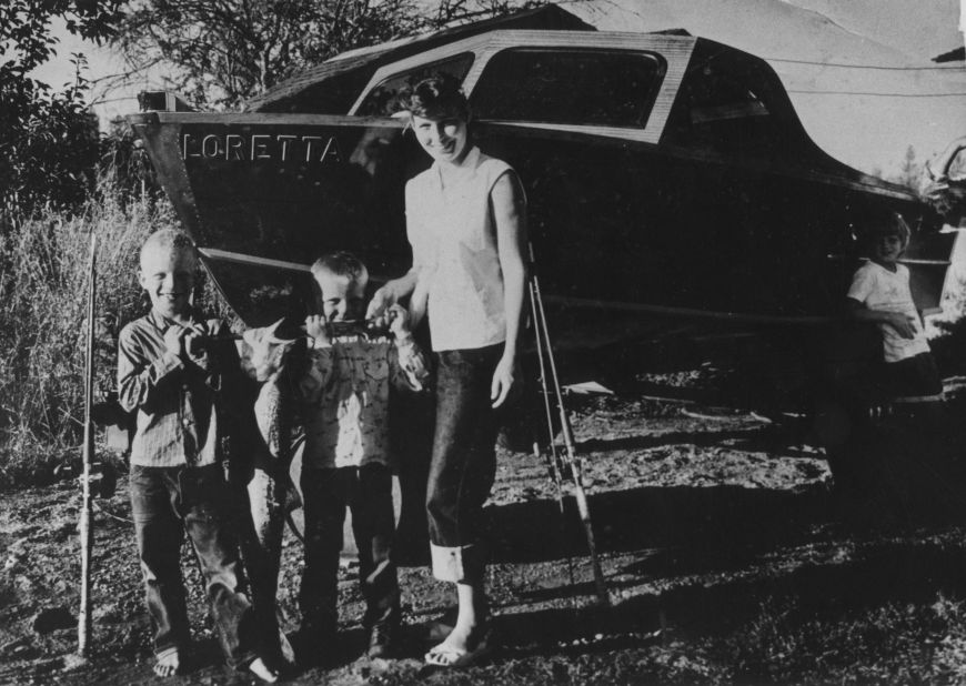 Lynn poses for a picture with three young boys in her hometown of Butcher Holler, Kentucky.