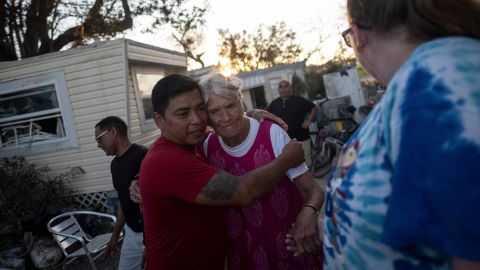 Carlos Hernandez hugs a neighbor in the aftermath of Hurricane Ian in Fort Myers Beach.