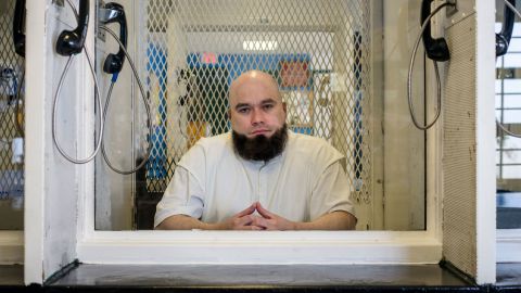 John Henry Ramirez sits in 2021 in the visitation area of a Texas prison in Livingston.
