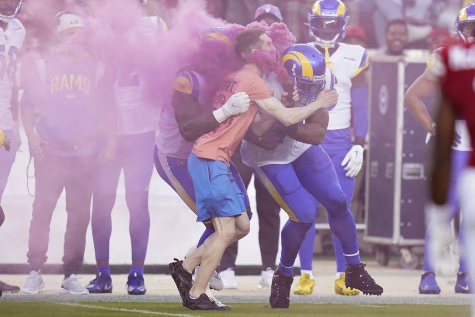 A protester meets the full force of Los Angeles Rams defensive end Takkarist McKinley, left, and linebacker Bobby Wagner during the Monday night game against the San Francisco 49ers on October 3. "He looked like he wasn't supposed to be on the field," Wagner told reporters after the game. "I saw security was having a little problem -- so I helped him out." The 49ers went on to dominate the Rams behind a stout defense that had seven sacks and an interception, winning 24-9 to move to 2-2 on the season.