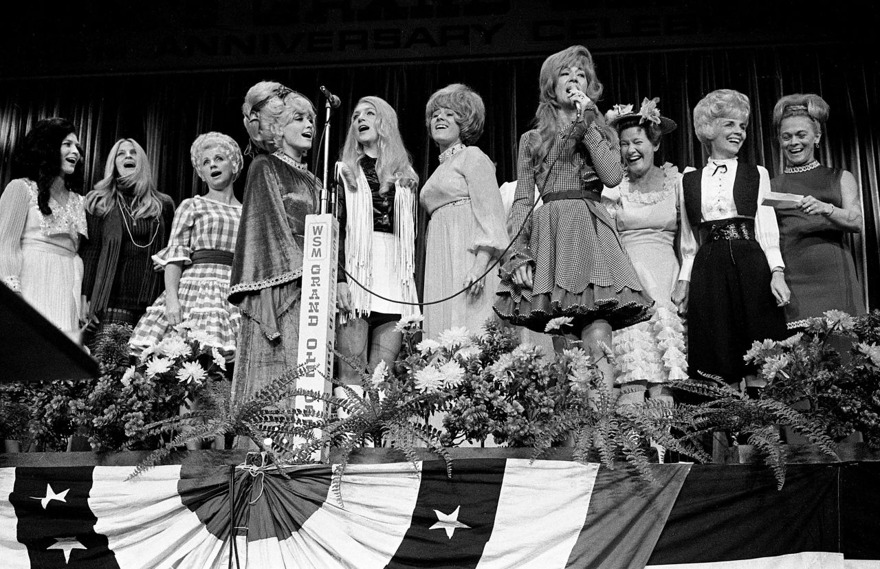 Lynn, left, joins fellow female country singers on stage as Dottie West, fourth from right, sings "Born To Be A Country Girl" at the Nashville Municipal Auditorium in 1970.