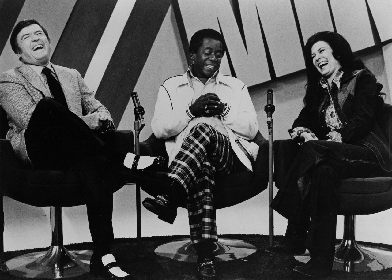Comedian Flip Wilson joins Lynn and Mike Douglas on "The Mike Douglas Show" in Los Angeles in 1974.
