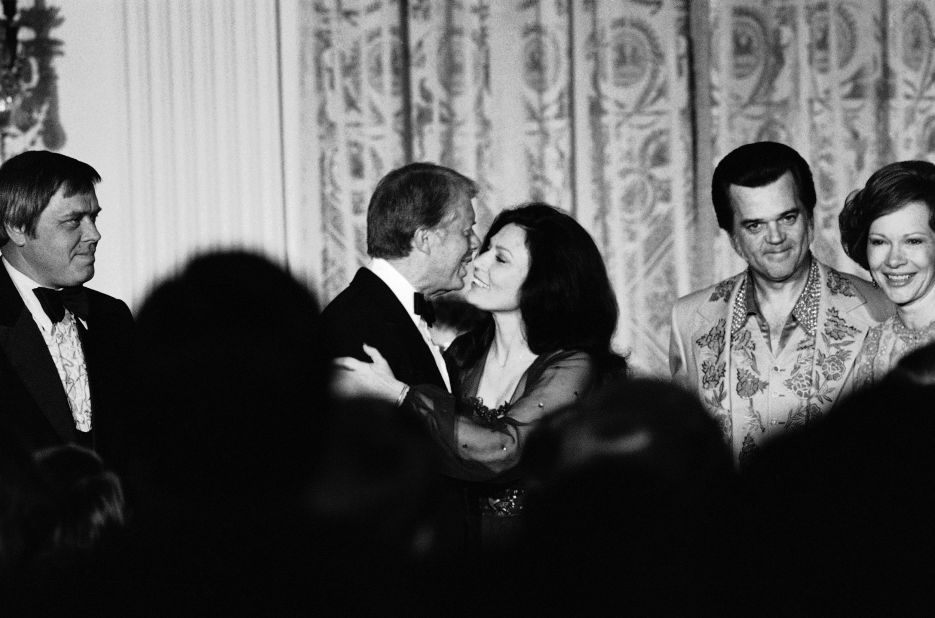 US President Jimmy Carter kisses Lynn during an evening of country music at the White House in 1978. 
