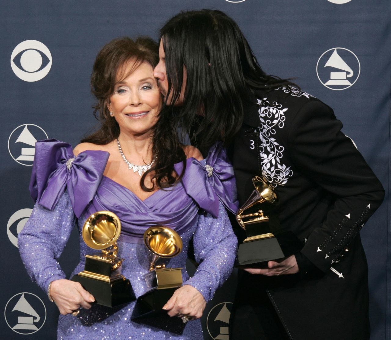 Jack White gives a kiss to Lynn after winning a Grammy together for best country collaboration in Los Angeles in February 2005. White produced her album "Van Lear Rose."