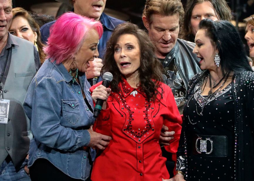From left, Tanya Tucker, Lynn and Crystal Gayle perform at Lynn's 87th birthday tribute at Bridgestone Arena in Nashville in 2019.