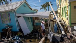 A man stands in front of his destroyed house in the aftermath of Hurricane Ian in Matlacha, Florida on October 3, 2022. - The confirmed death toll from Hurricane Ian, which slammed the southeast United States last week, has risen to at least 62, officials said October 2, 2022. (Photo by Ricardo ARDUENGO / AFP) (Photo by RICARDO ARDUENGO/AFP via Getty Images)