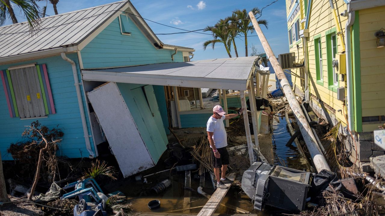 A man stands in front of his destroyed house in the aftermath of Hurricane Ian in Matlacha, Florida on Monday.