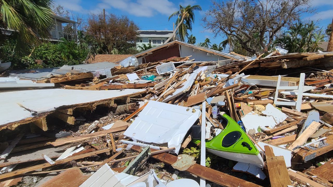 Debris lies around Bill Veach's badly damaged home in Fort Myers Beach.