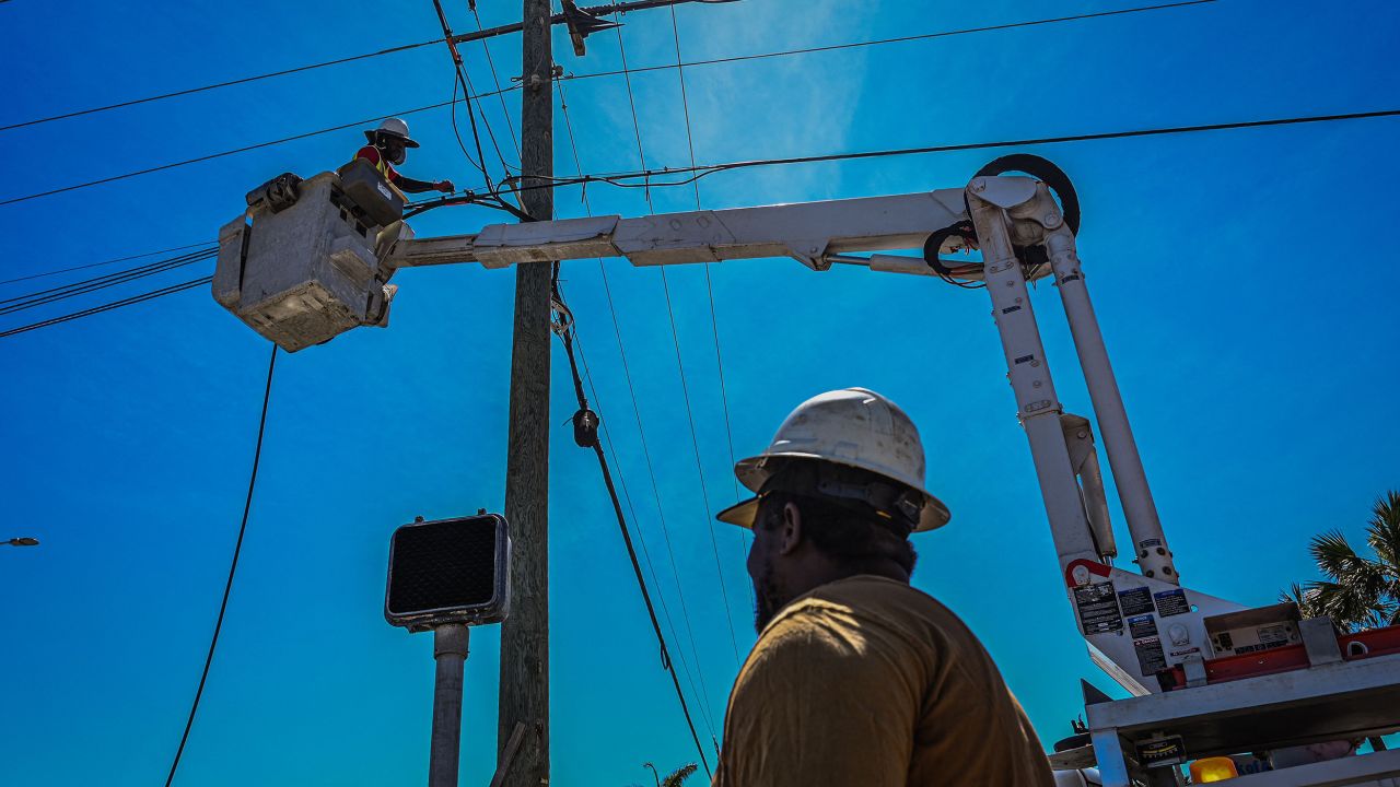 Florida Power & Light Company workers check the lines on Fort Myers Beach after Hurricane Ian on Friday.