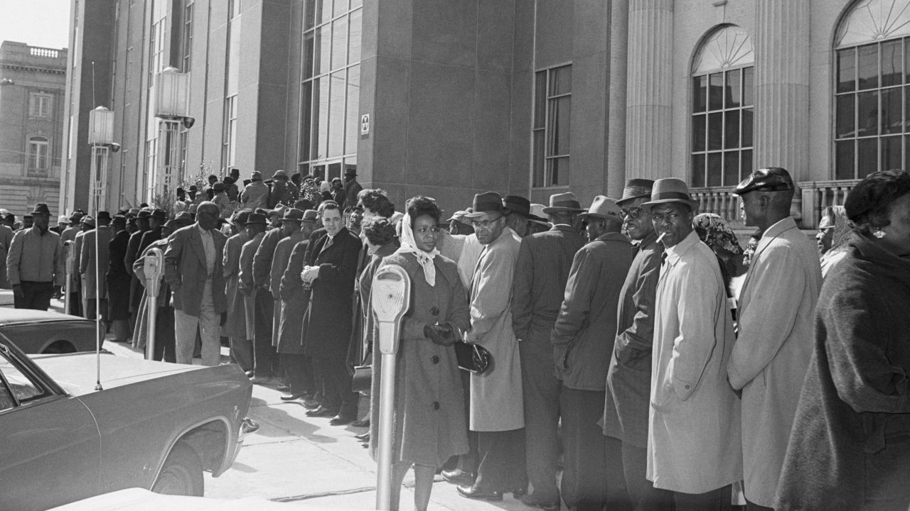 Led by Martin Luther King Jr, people line up in front of the Dallas County Courthouse in Selma, Alabama, to register to vote.