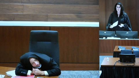 Darrell Brooks appears to a jury by video from an adjacent courtroom after repeatedly interrupting Judge Jennifer Dorow (right) in Waukesha County Circuit Court, Monday, Oct. 3 Wear his blazer over his head during regiment selection.