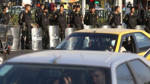 Iranian riot police stand on a street in Tehran.