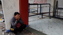 An Arema FC supporter cries near an entrance gate at the Kanjuruhan stadium.