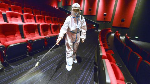 A worker wearing personal protective equipment disinfects a cinema on August 9 in Urumqi, Xinjiang, China. 