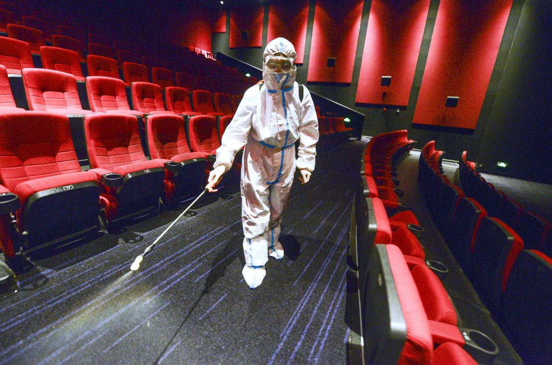 A worker wearing personal protective equipment disinfects a cinema on August 9 in Urumqi, Xinjiang, China. 