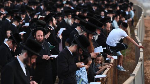 Ultra-Orthodox Jewish men and children perform the "Tashlich" ritual, during which "sins are cast into the water to the fish," ahead of the Day of Atonement, or Yom Kippur -- the most important day in the Jewish calendar -- in the coastal Mediterranean Israeli city of Netanya on Monday.  