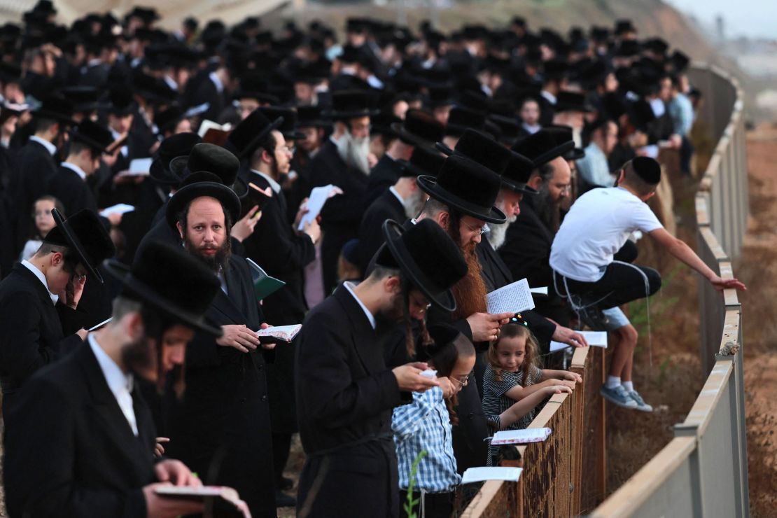 Ultra-Orthodox Jewish men and children perform the "Tashlich" ritual, during which "sins are cast into the water to the fish," ahead of the Day of Atonement, or Yom Kippur -- the most important day in the Jewish calendar -- in the coastal Mediterranean Israeli city of Netanya on Monday.  