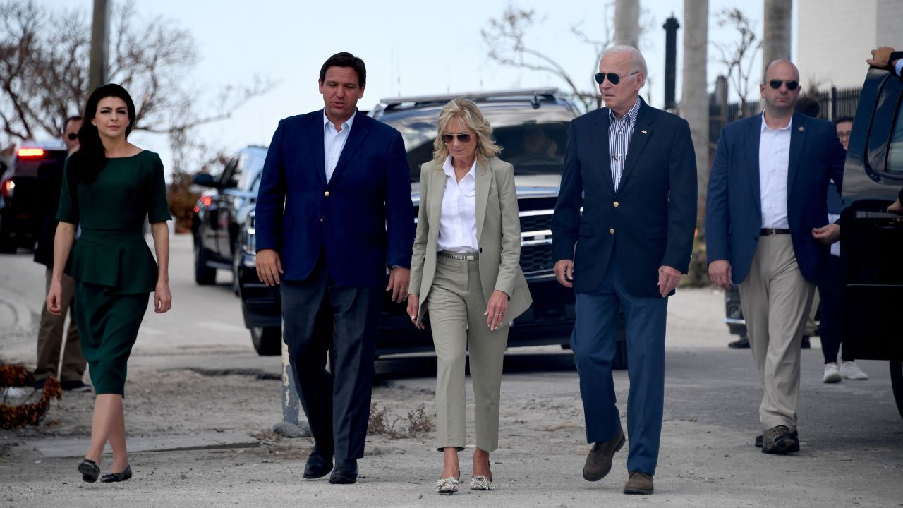 Biden and DeSantis and their wives walk to meet with local residents affected by Hurricane Ian in Fort Myers, Florida, on October 5, 2022.