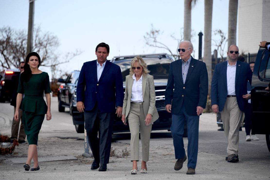 Biden and DeSantis and their wives walk to meet with local residents affected by Hurricane Ian in Fort Myers, Florida, on October 5, 2022.