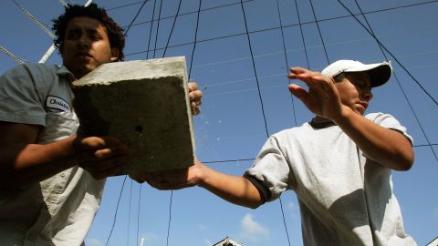 This file photo from April 2006 shows immigrant workers performing "house leveling" work on a New Orleans home damaged by Huricane Katrina. 