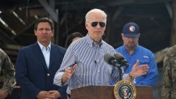 US President Joe Biden speaks in a neighborhood impacted by Hurricane Ian at Fishermans Pass in Fort Myers, Florida, on October 5, 2022 as Florida Governor Ron DeSantis looks on. (Photo by OLIVIER DOULIERY / AFP) (Photo by OLIVIER DOULIERY/AFP via Getty Images)